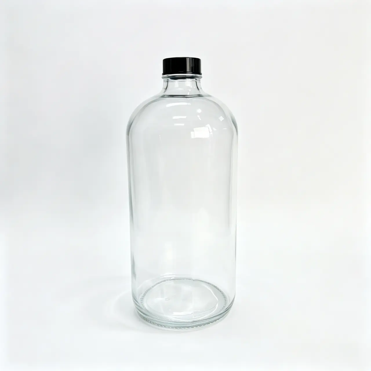 1000ml Clear Boston Round Bottle Front View 1000ml clear Boston round bottle shown from the front with matching cap and transparent cylindrical body