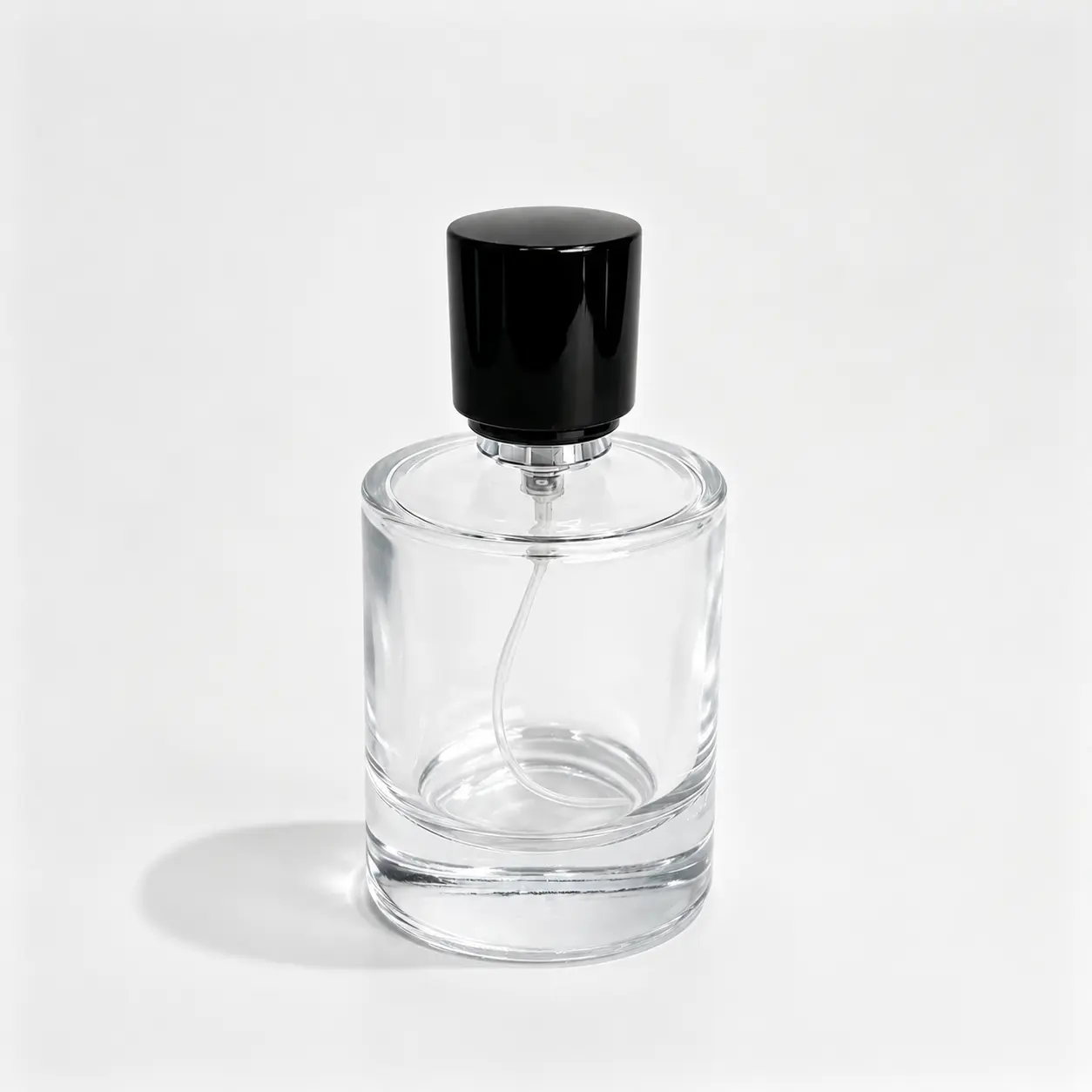 100ml clear cylindrical glass perfume bottle shown in complete front view with crimp sprayer and outer cap