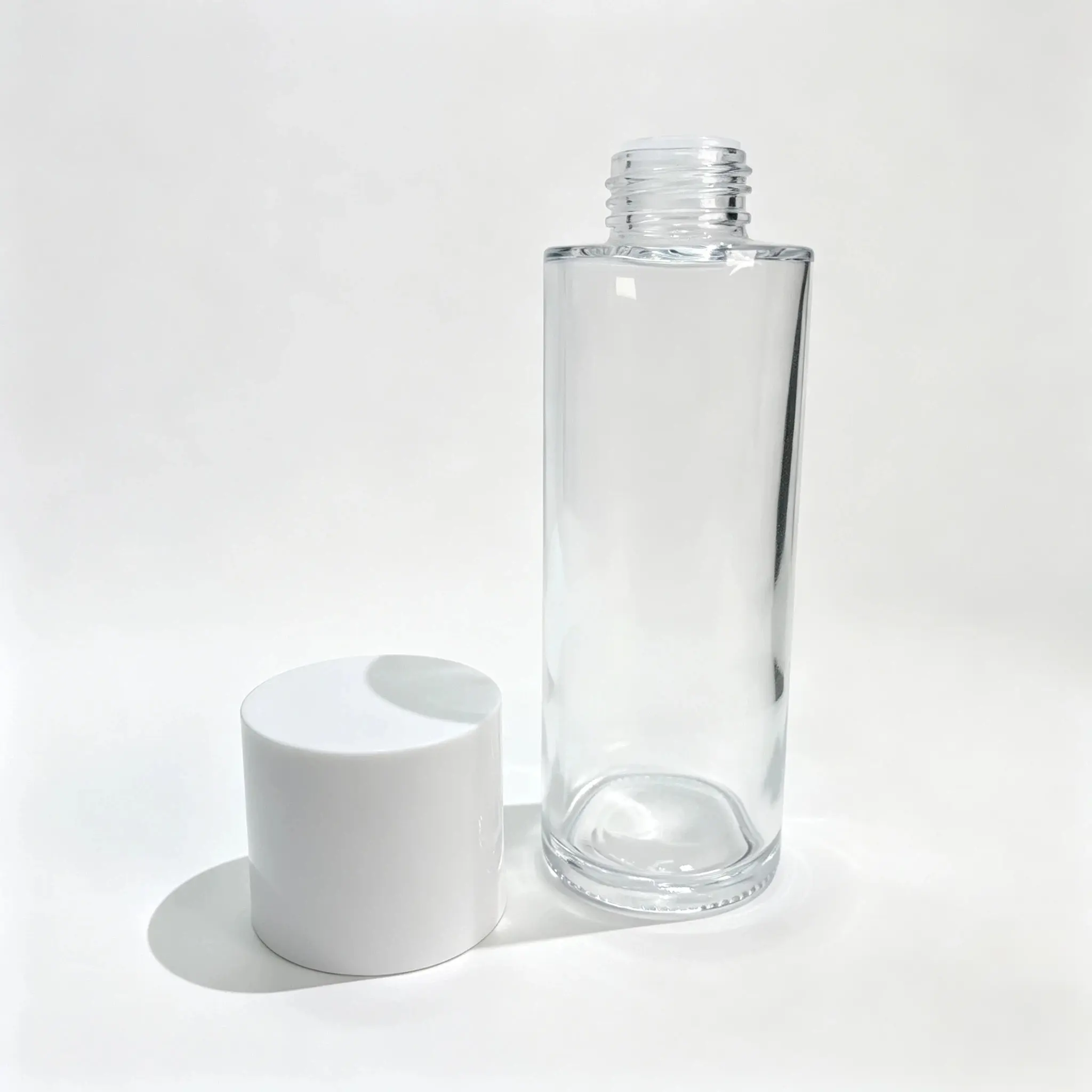 100ml Facial Toner Glass Bottle with Cap 100ml facial toner glass bottle displayed with its separate bottle cap component