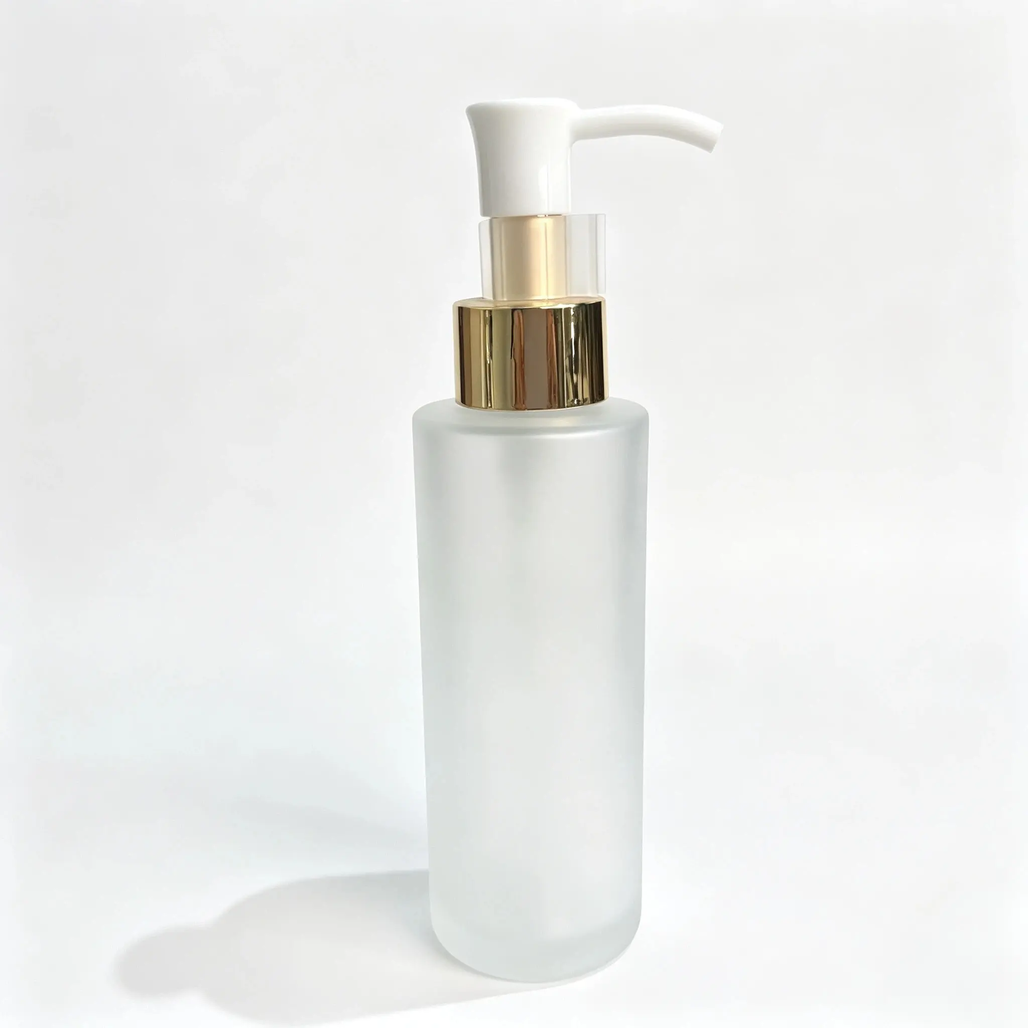 Front view of the complete 100ml frosted glass lotion bottle assembled with its dispensing components
