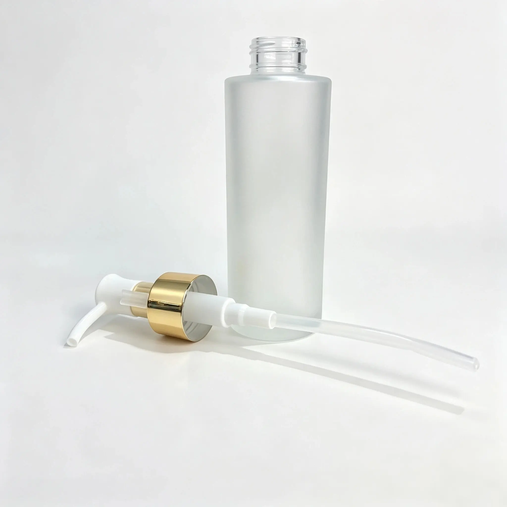 100ml frosted glass lotion bottle displayed together with its separate sprayer component