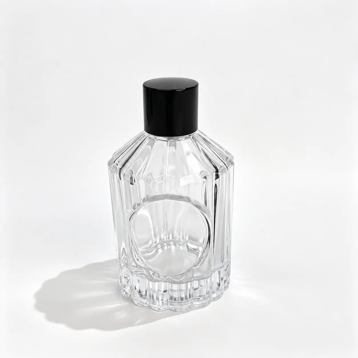 100ml ribbed glass perfume bottle shown in complete front view with vertical embossed detailing and a round logo panel