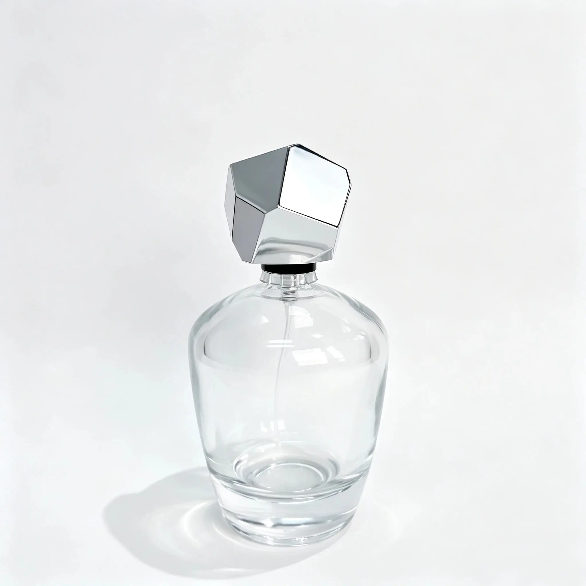 100ml Rounded Glass Perfume Bottle Front View 100ml rounded glass perfume bottle shown in complete front view with crimp sprayer and geometric faceted outer cap