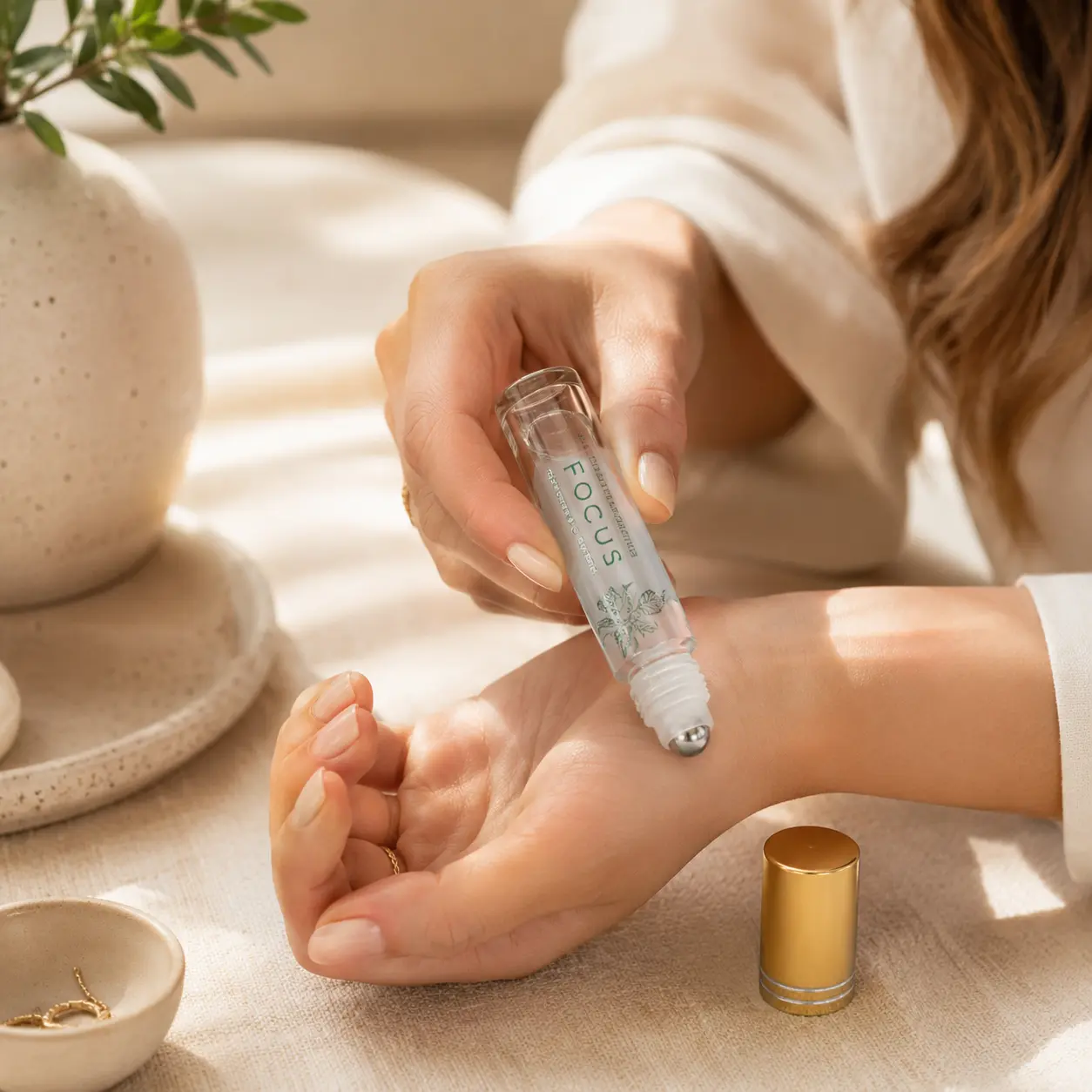 10ml Clear Glass Roll On Perfume Bottle Hand Application Scene 10ml clear glass roller ball perfume bottle being used by hand with the roll-on applicator exposed