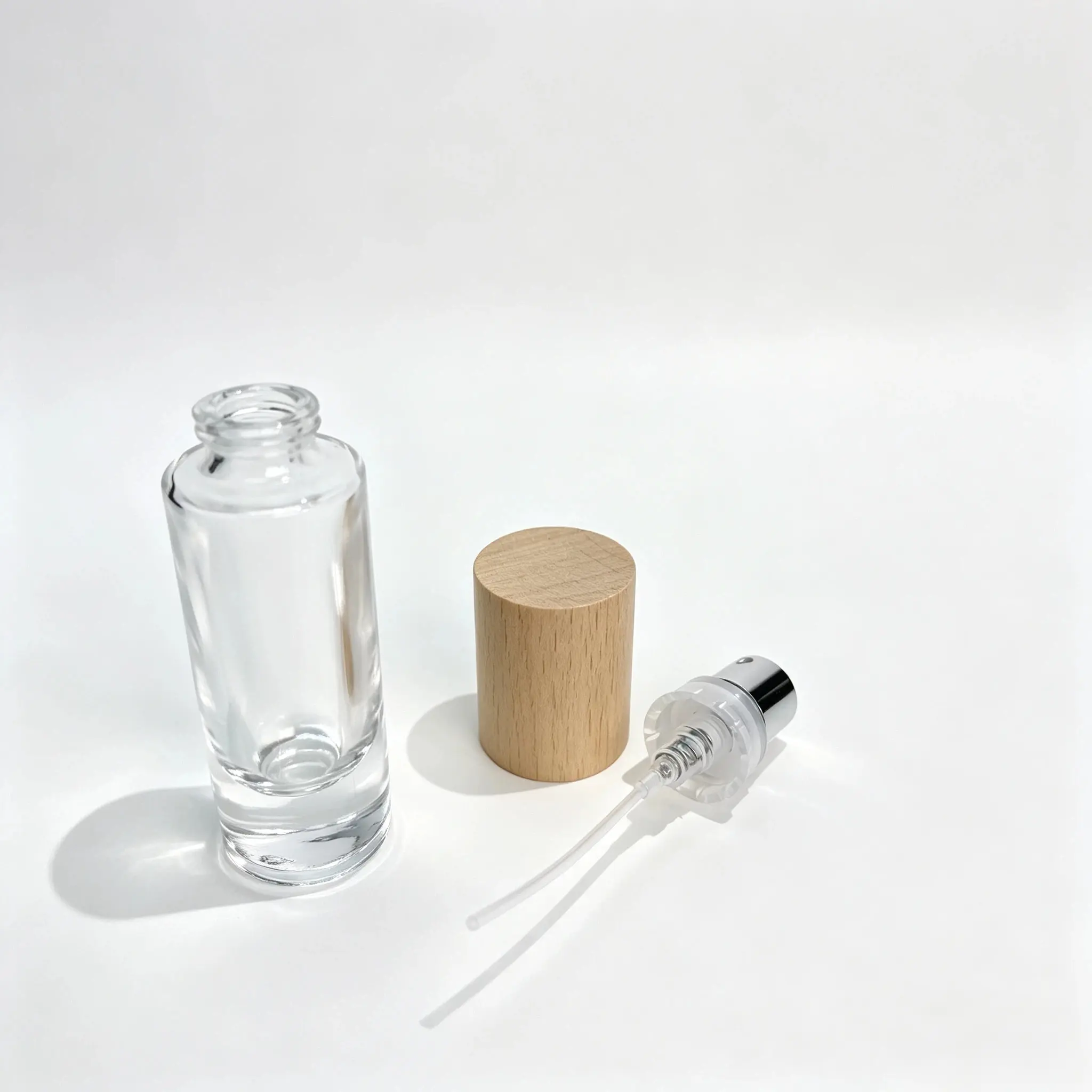 10ml Cylindrical Glass Perfume Bottle with Cap and Crimp Sprayer 10ml cylindrical glass perfume bottle shown bare with the outer cap and crimp sprayer displayed separately for component reference
