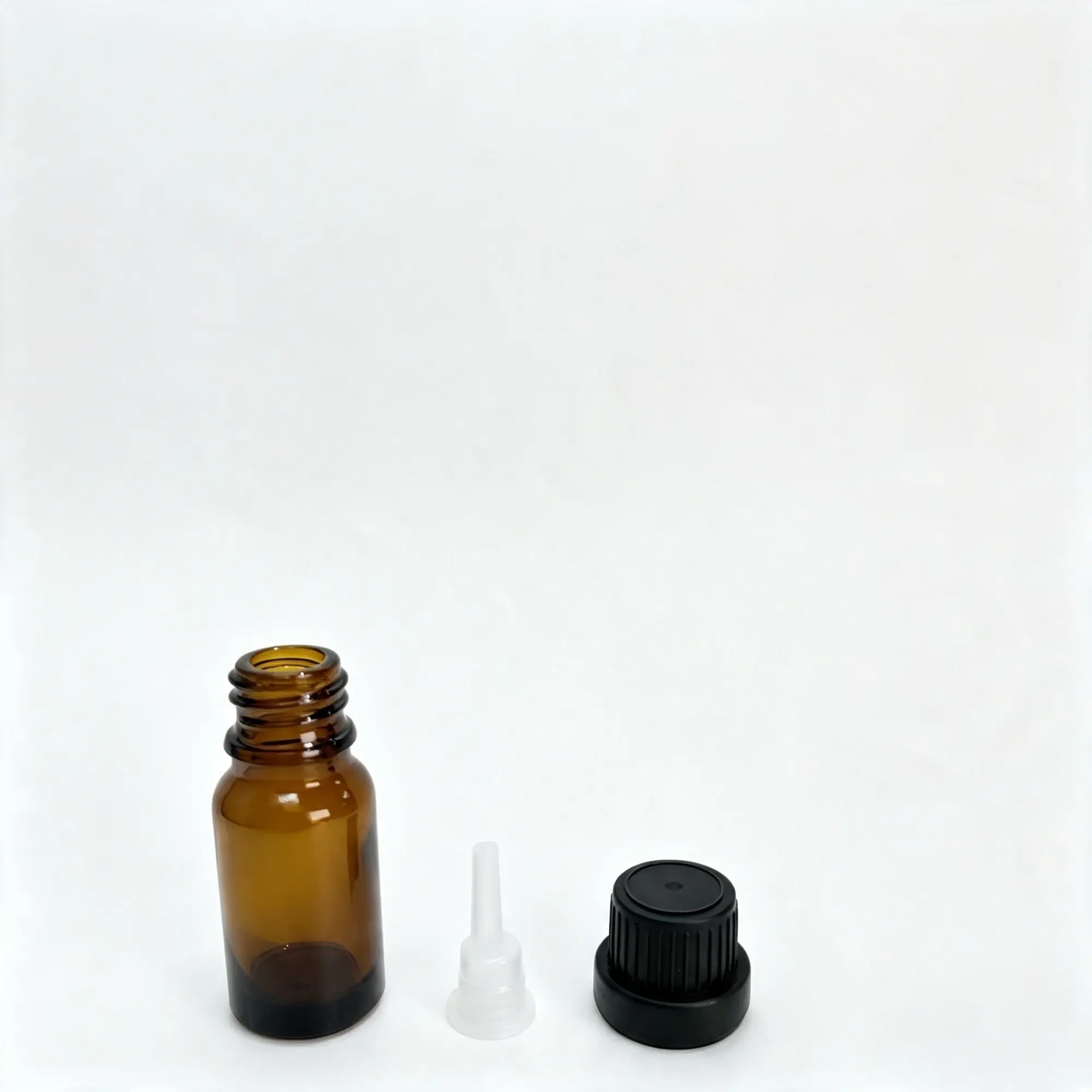 Uncapped 10ml Euro dropper essential oil bottle displayed with the separate inner insert and black outer cap
