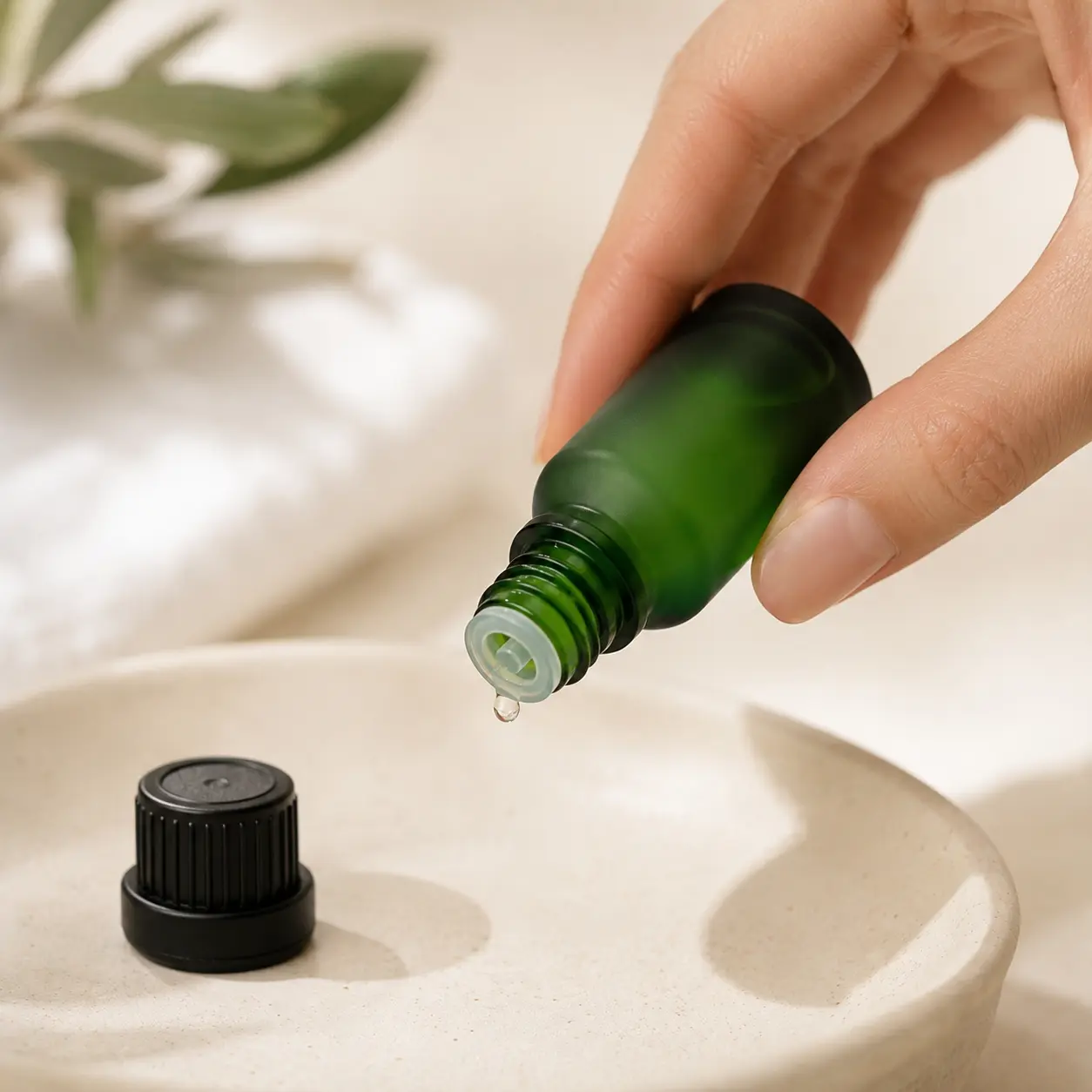 15ml Frosted Green Euro Dropper Essential Oil Bottle Dispensing Oil 15ml frosted green Euro dropper essential oil bottle dispensing a visible drop from the bottle opening