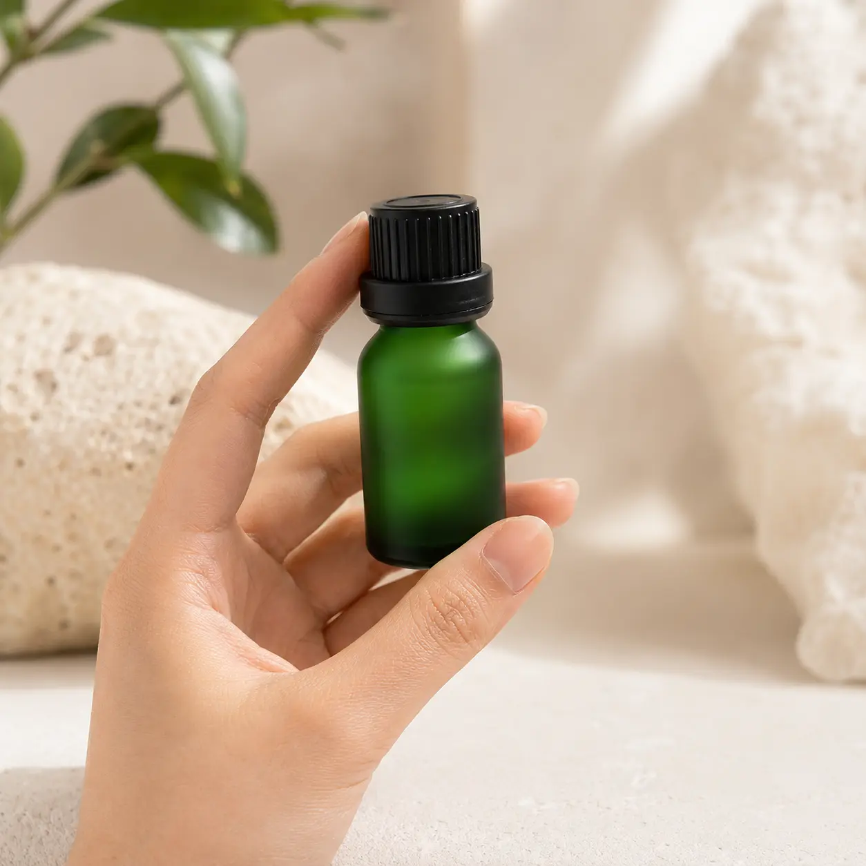 15ml Frosted Green Euro Dropper Essential Oil Bottle Handheld View 15ml frosted green Euro dropper essential oil bottle held in one hand to show its compact bottle size and black closure
