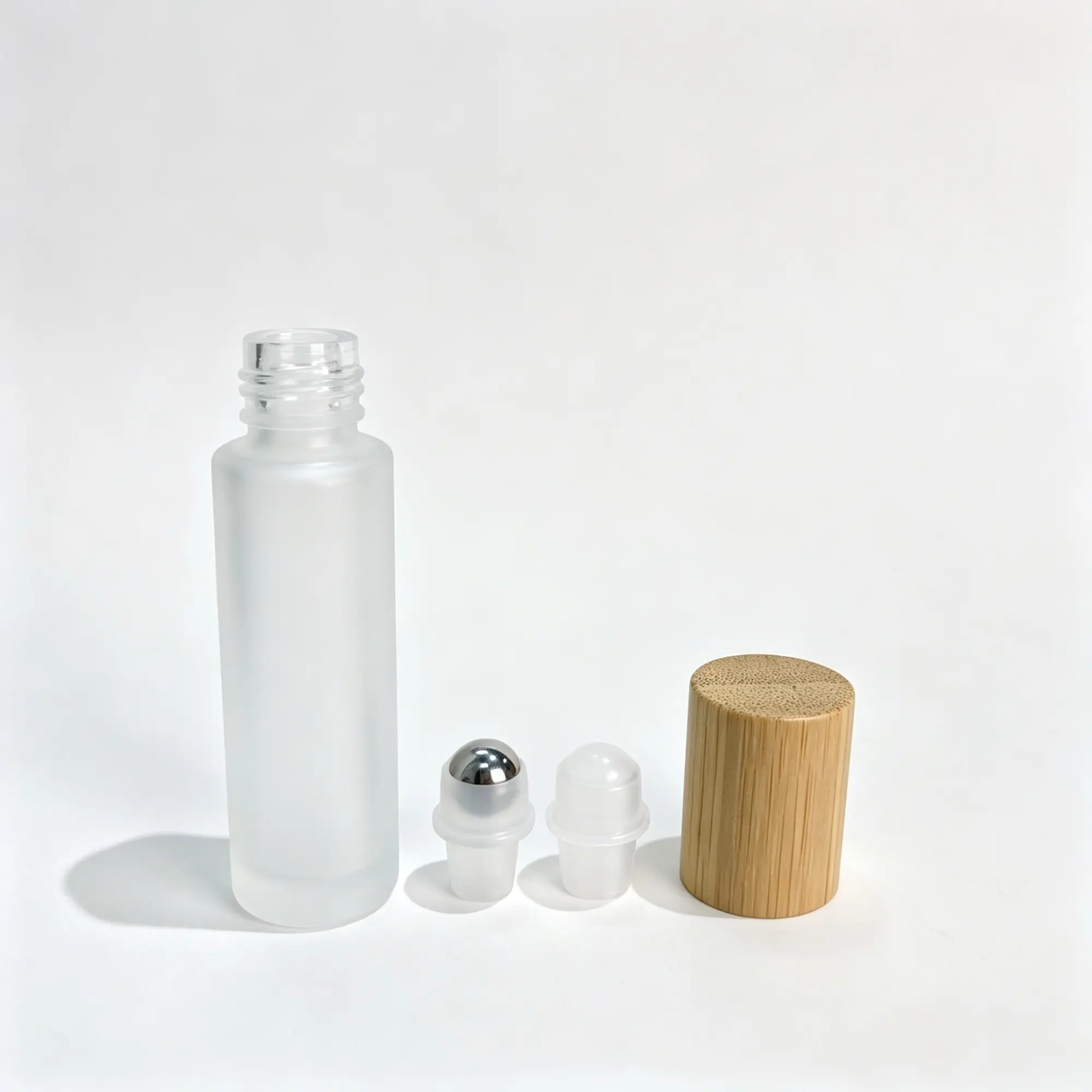 20ml Frosted Glass Roller Bottle Roller Ball and Cap Options 20ml frosted glass roller bottle shown with glass and stainless steel roller ball options and wooden closure