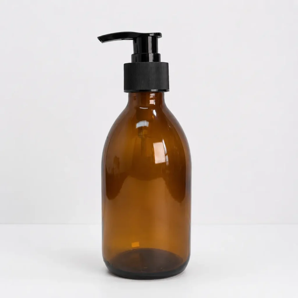 250ml amber Boston Round lotion bottle shown from the front with the sprayer assembled.