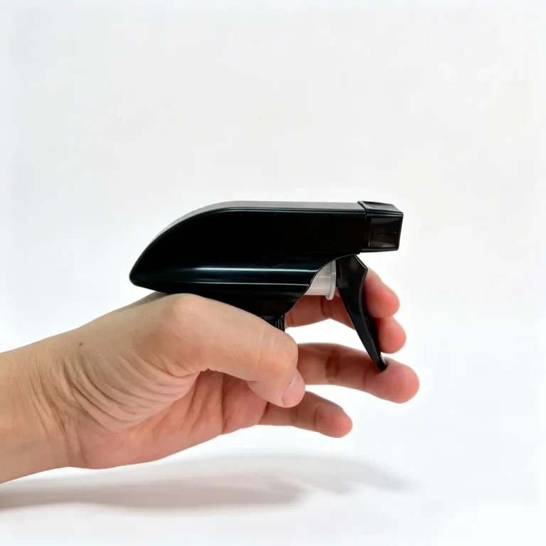 Hand holding a 28/410 black square trigger sprayer to show the overall size and handling profile