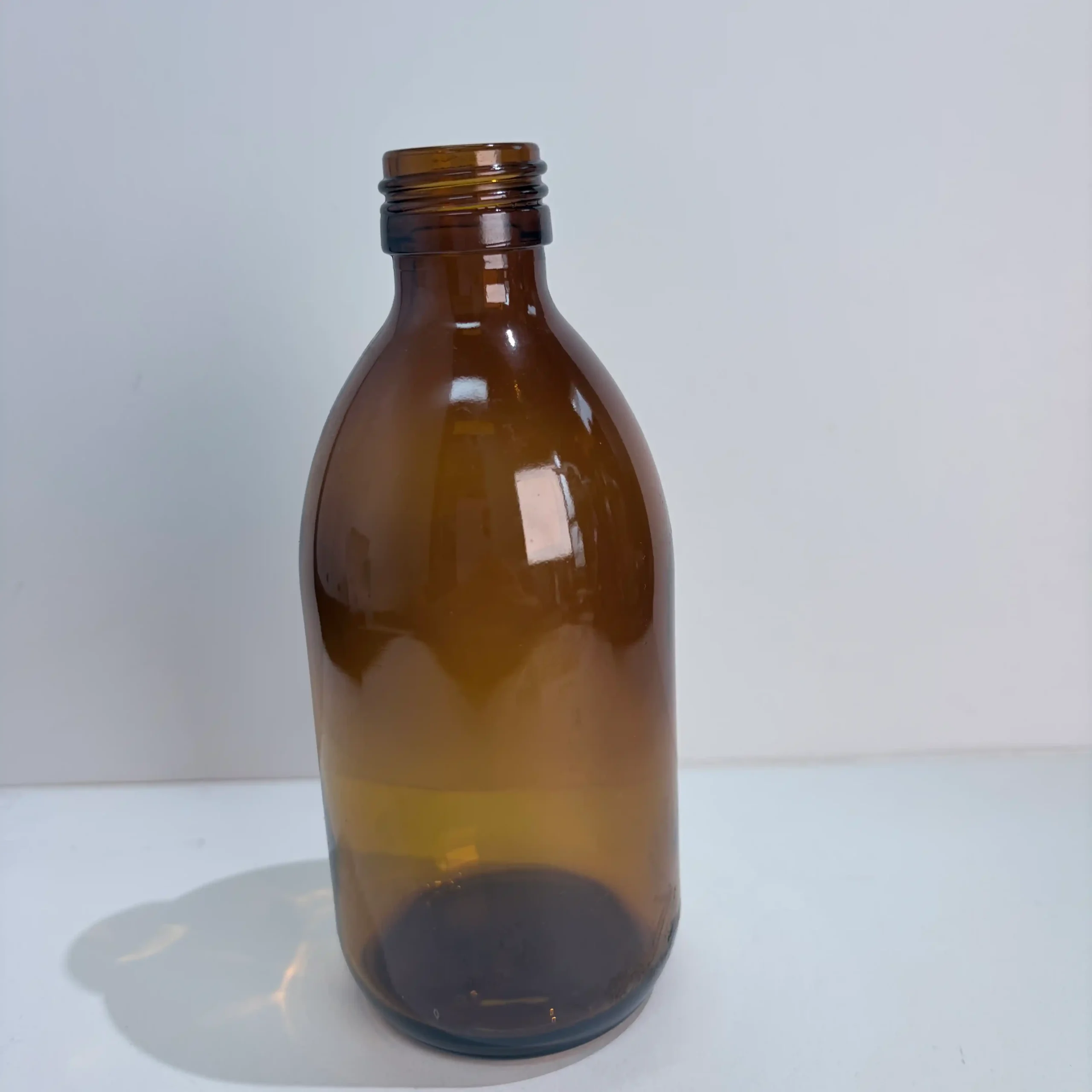 300ml Amber Boston Round Bottle Bare Bottle Front View Bare 300ml Boston Round amber bottle shown from the front with the threaded neck visible