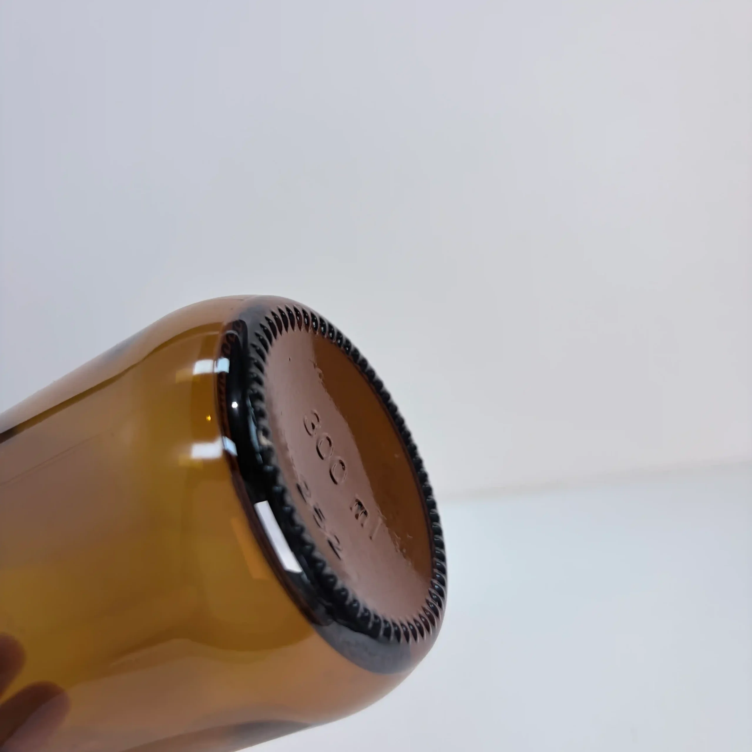 300ml Amber Boston Round Bottle Base Detail Close view of the base structure of the 300ml Boston Round amber bottle