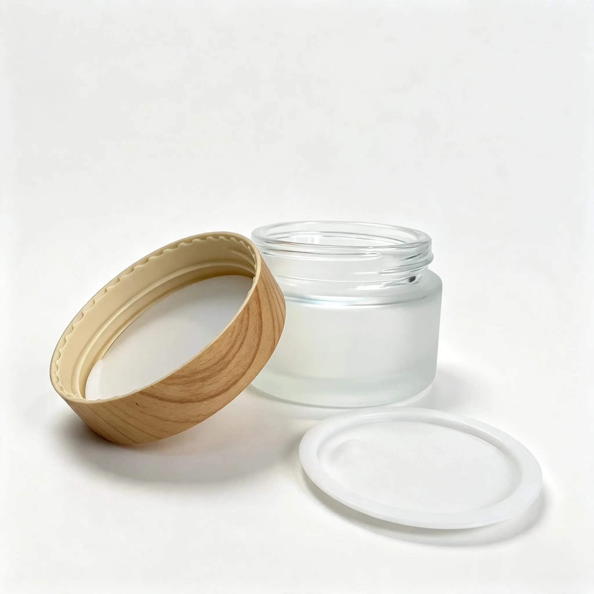 30g frosted glass cosmetic cream jar shown with matching cap and inner pull lid components