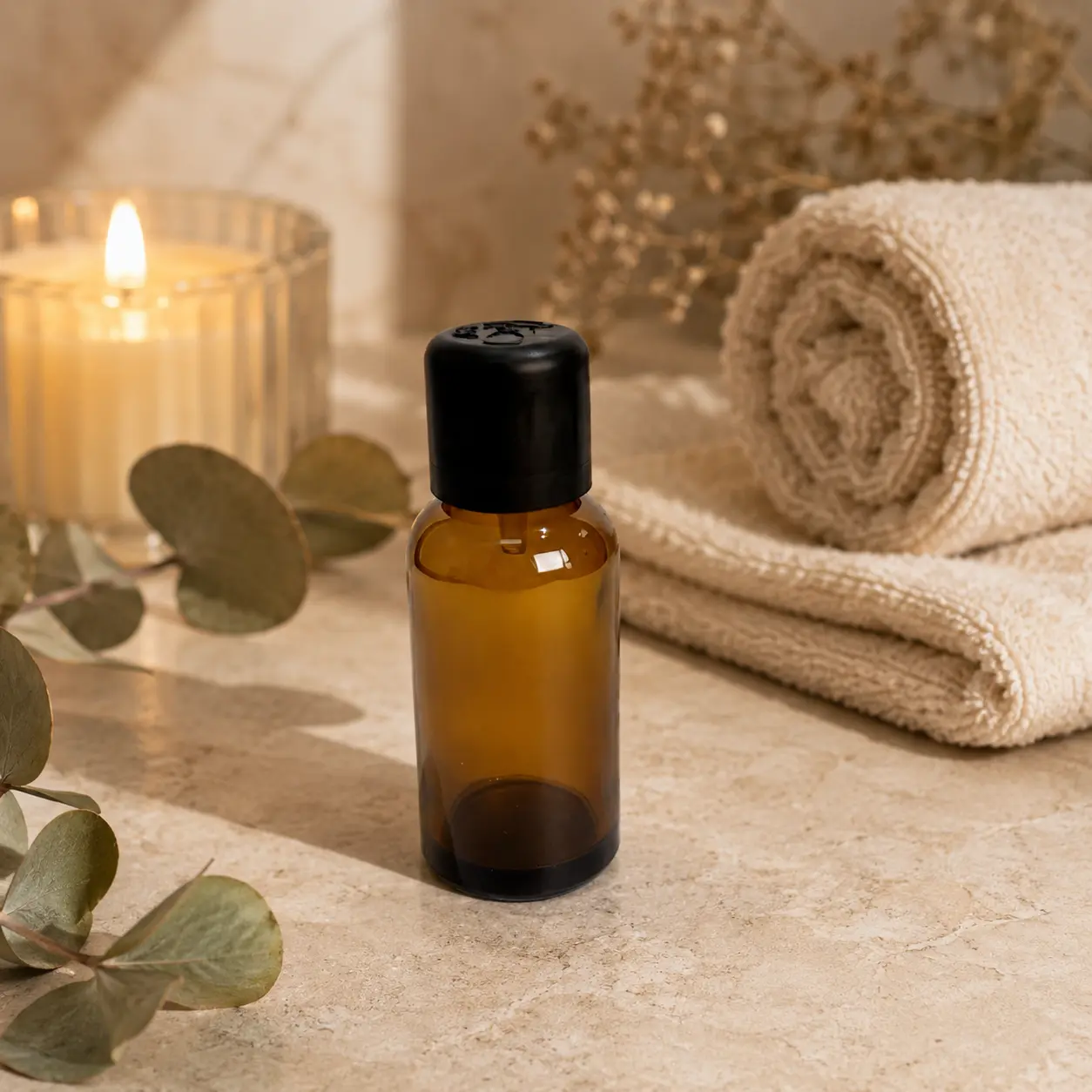 30ml amber Euro dropper essential oil bottle displayed beside a candle in an aromatherapy-style setting