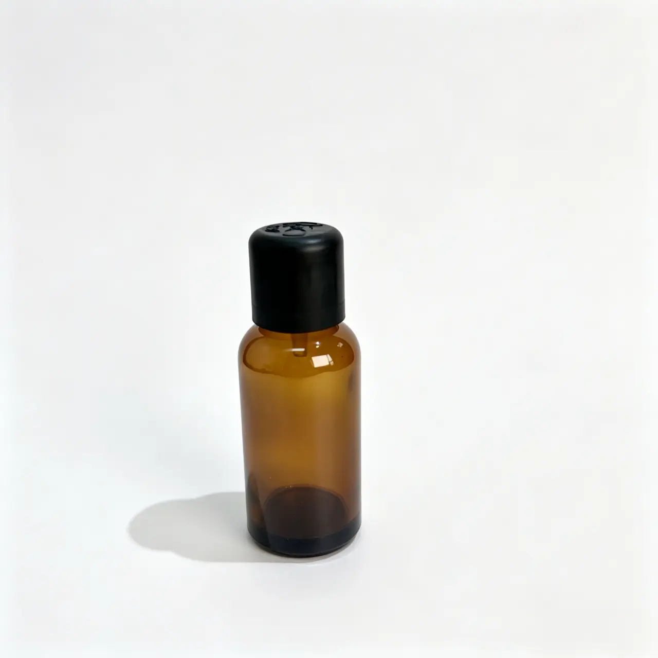 30ml amber Euro dropper essential oil bottle shown upright from the front with black closure