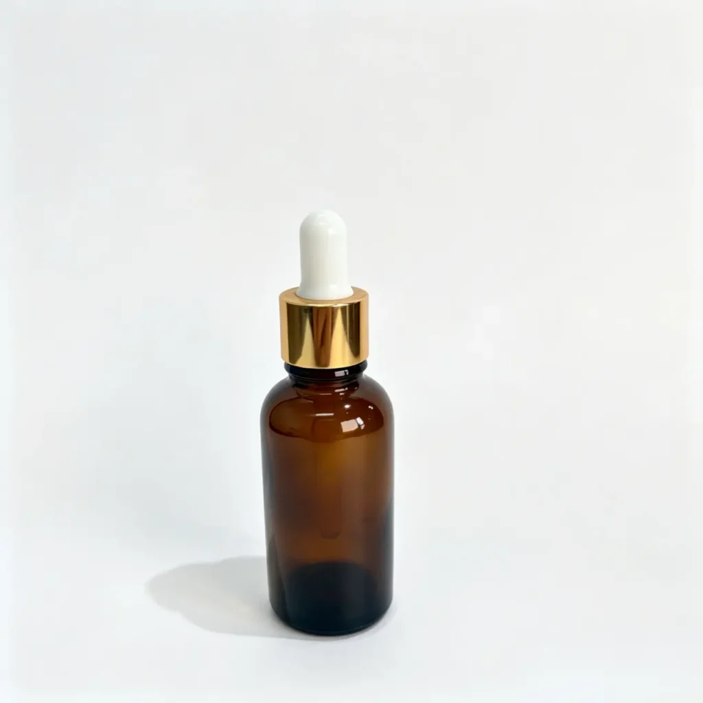 30ml amber Boston round oil dropper bottle shown upright with a gold-colored dropper closure