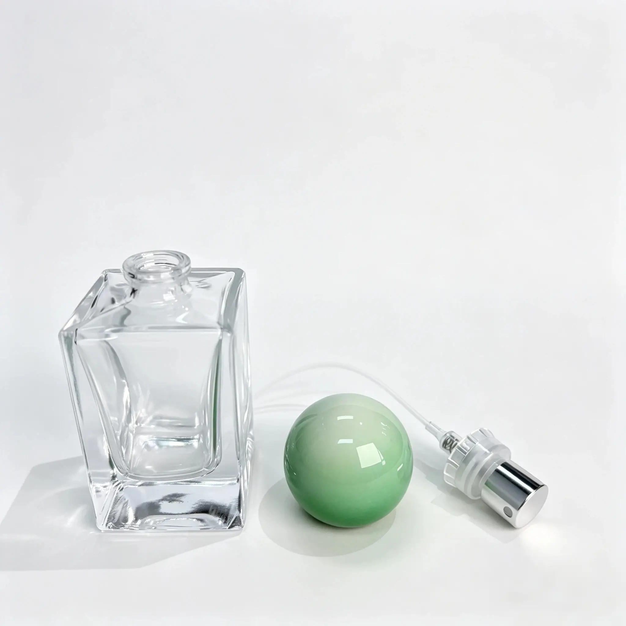 30ml double layer glass perfume bottle shown bare with the green ball shaped outer cap displayed separately beside the bottle