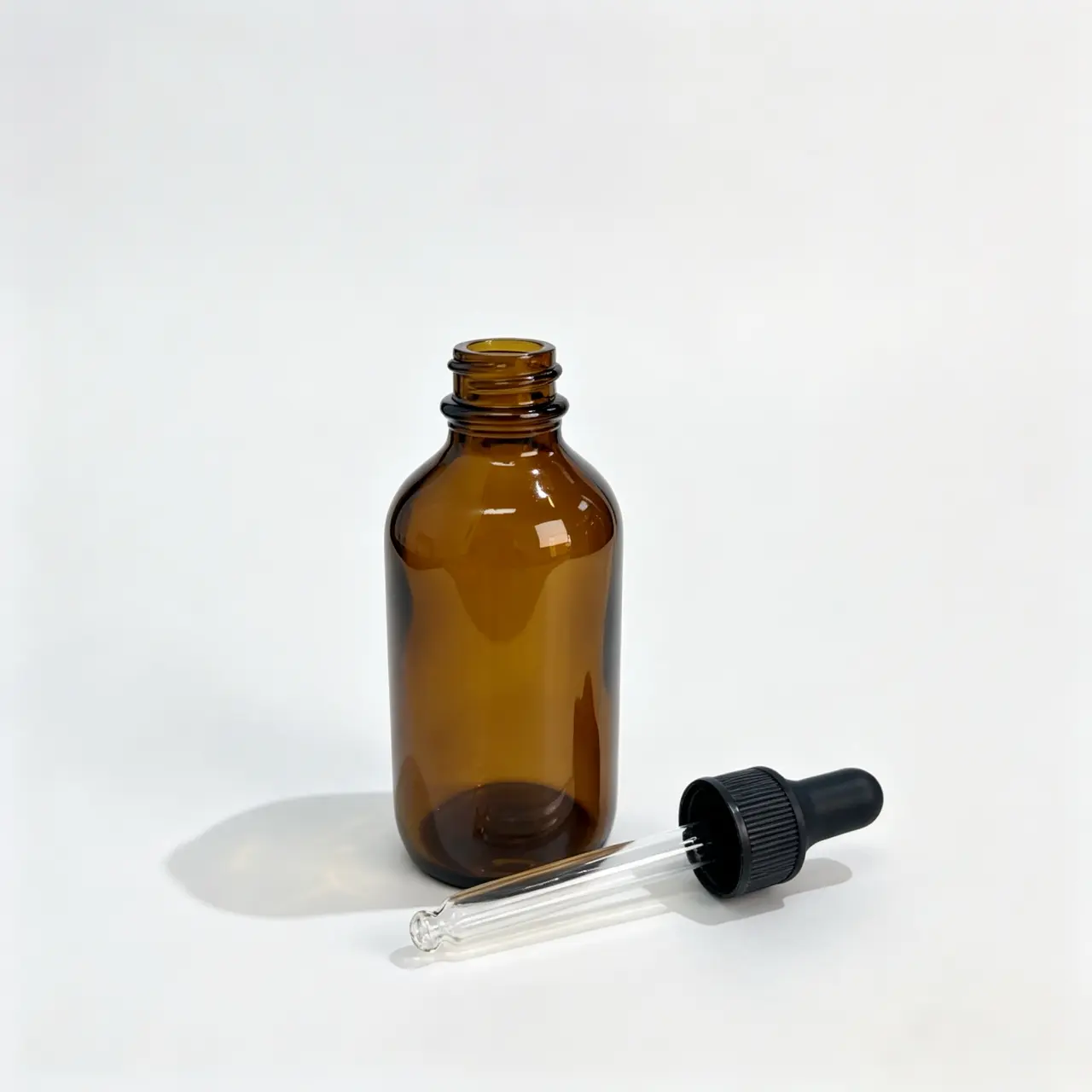 30ml-Gold-Boston-Round-Oil-Bottle-and-Dropper-Side-View 30ml gold Boston round oil bottle and matching dropper shown separately in a side-lying view