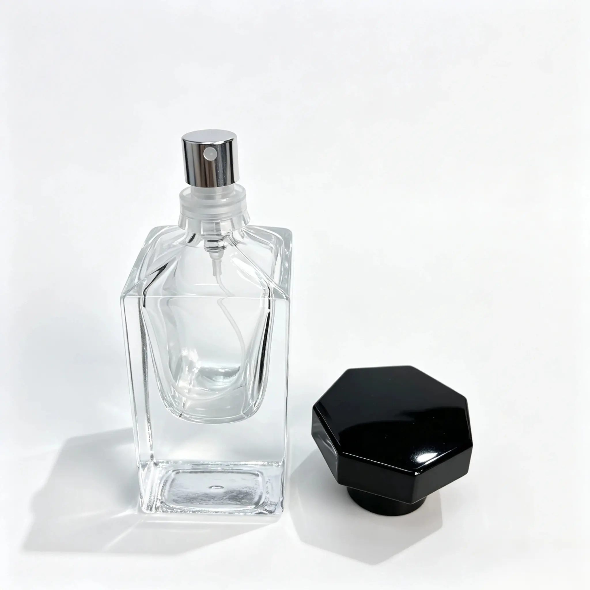 30ml Square Glass Perfume Bottle with Separate Black Cap 30ml square glass perfume bottle shown bare with the octagonal black outer cap displayed separately beside the bottle