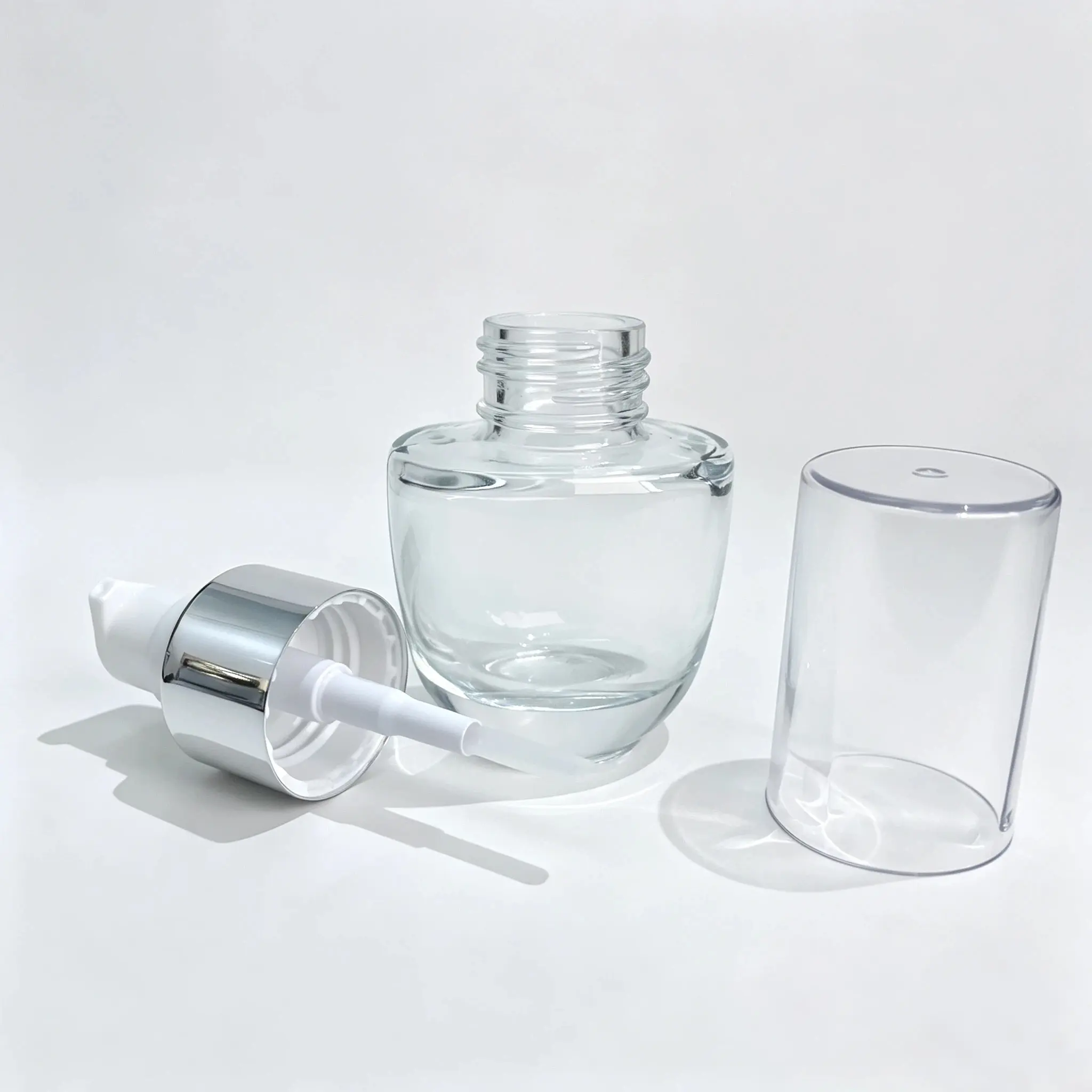 30ml Transparent Lotion Bottle with Cap and Pump 30ml transparent lotion bottle shown with separate cap and dispensing head components for packaging configuration reference