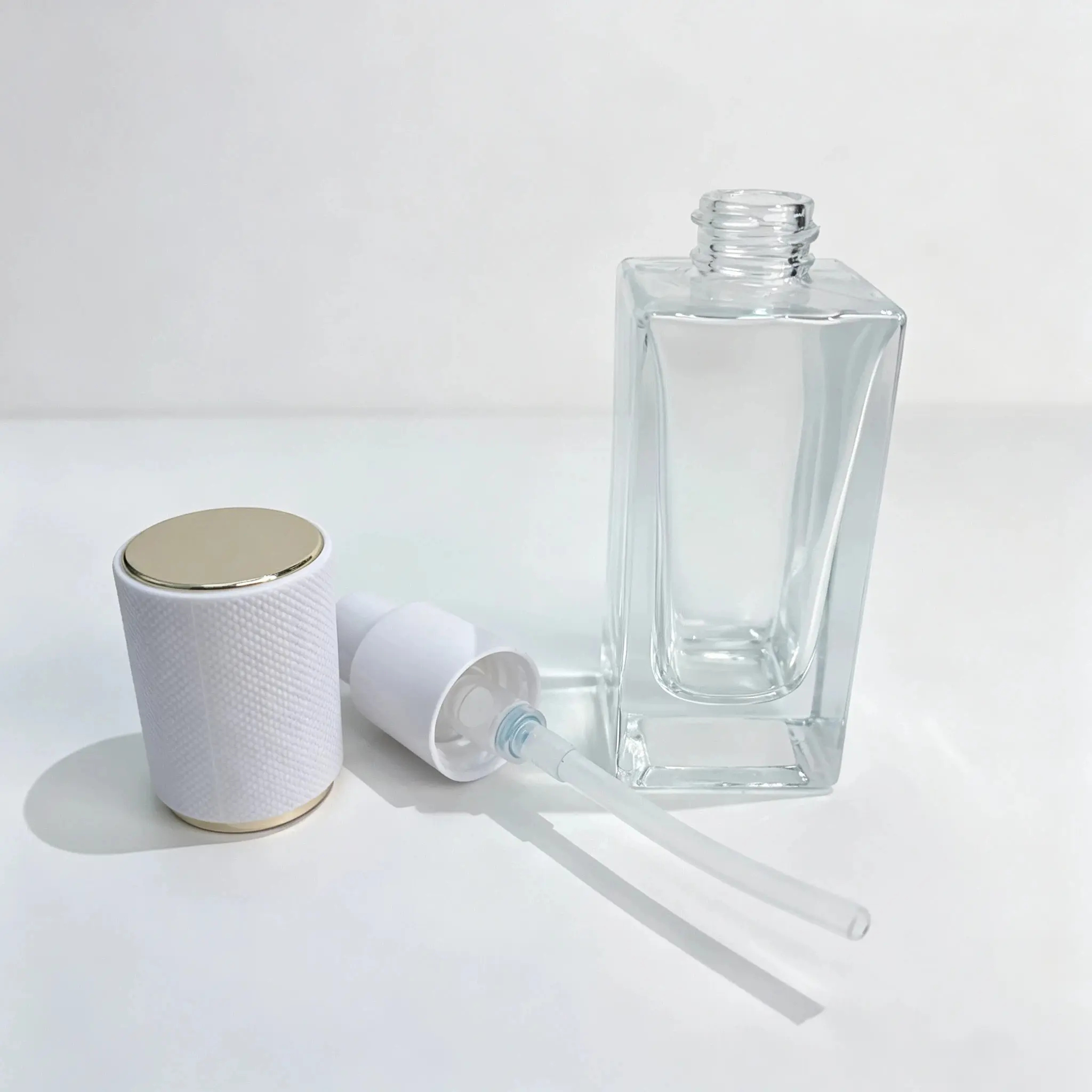 50ml Clear Glass Lotion Bottle Pump and Cap Components 50ml clear glass lotion bottle displayed with its separate pump and cap components for packaging configuration reference