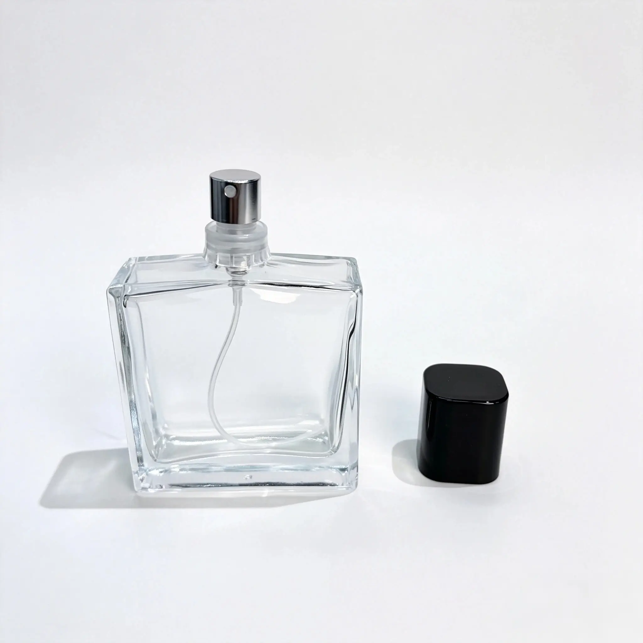 50ml Custom Faceted Perfume Bottle Without Cap 50ml custom faceted perfume bottle shown bare from the front with the outer cap displayed separately