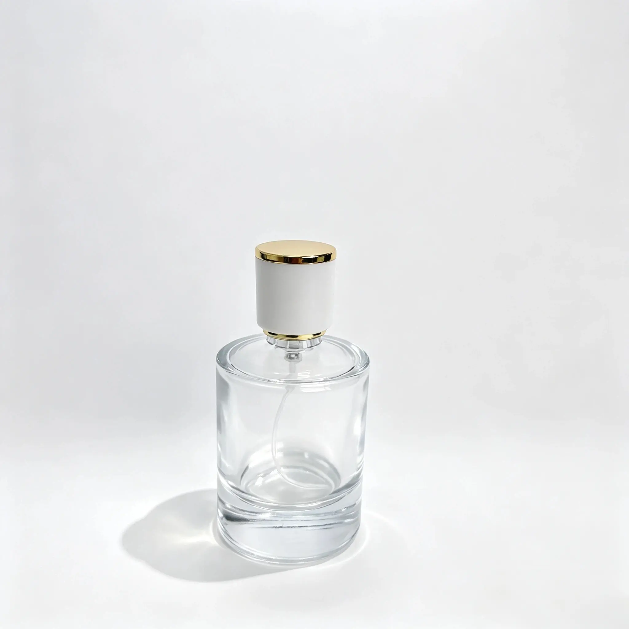 50ml Perfume Bottle Front View 50ml round cologne bottle shown in complete front view with crimp sprayer and white and gold cylindrical outer cap