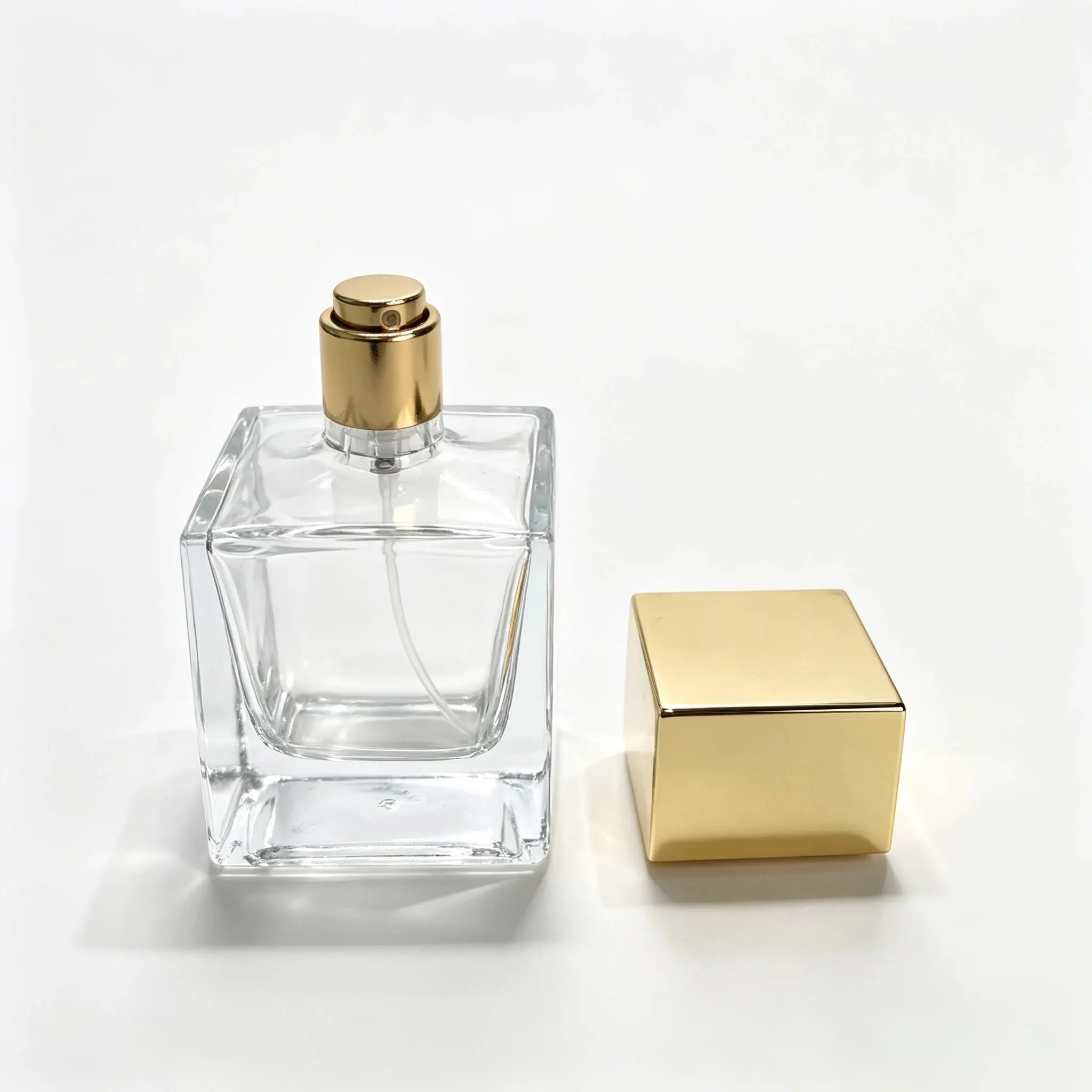 50ml Square Recessed Perfume Bottle with Separate Gold Cap 50ml square recessed perfume bottle shown bare with the gold square outer cap displayed separately beside the bottle