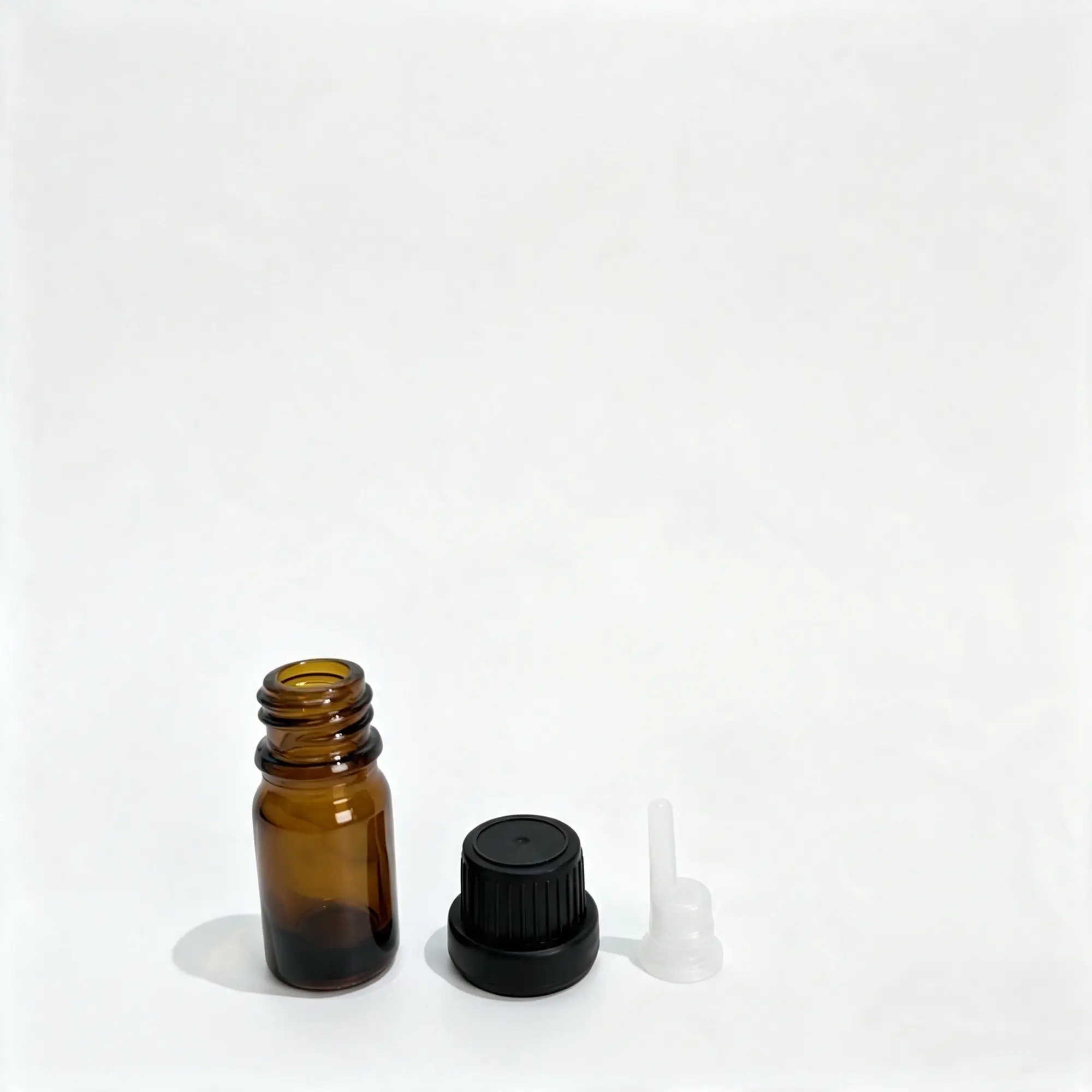 5ml Euro dropper essential oil bottle displayed with its separate insert and black cap components