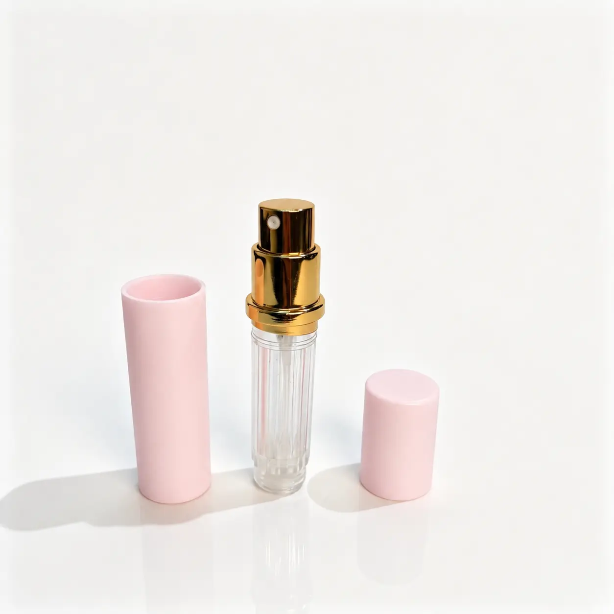 5ml Pink Perfume Atomizer Inner Bottle and Outer Shell 5ml pink refillable perfume atomizer shown with the PCTG inner bottle and ABS outer shell separated for component reference