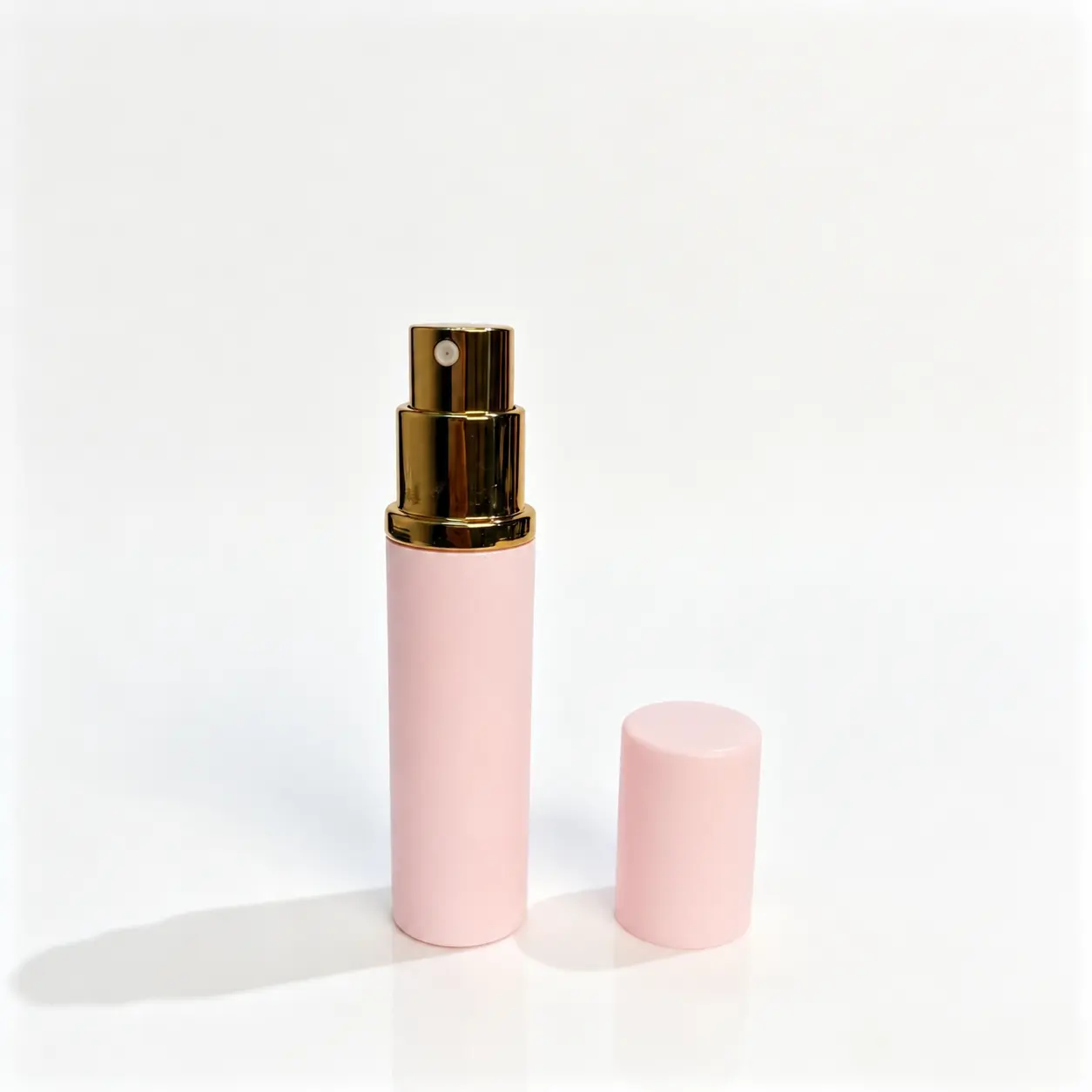 5ml Pink Refillable Perfume Atomizer with Upright Cap 5ml pink refillable perfume atomizer shown with the bottle body and outer cap standing separately beside each other