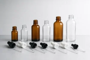 Glass dropper pipettes positioned beside serum bottles of different heights