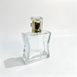 Side profile of the 100ml hourglass perfume bottle showing its slim 32 mm body depth and overall silhouette with the cap attached.