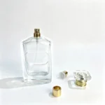 100ml multifaceted perfume bottle displayed without its cap alongside the separate fragrance sprayer, dip tube, and cap components.