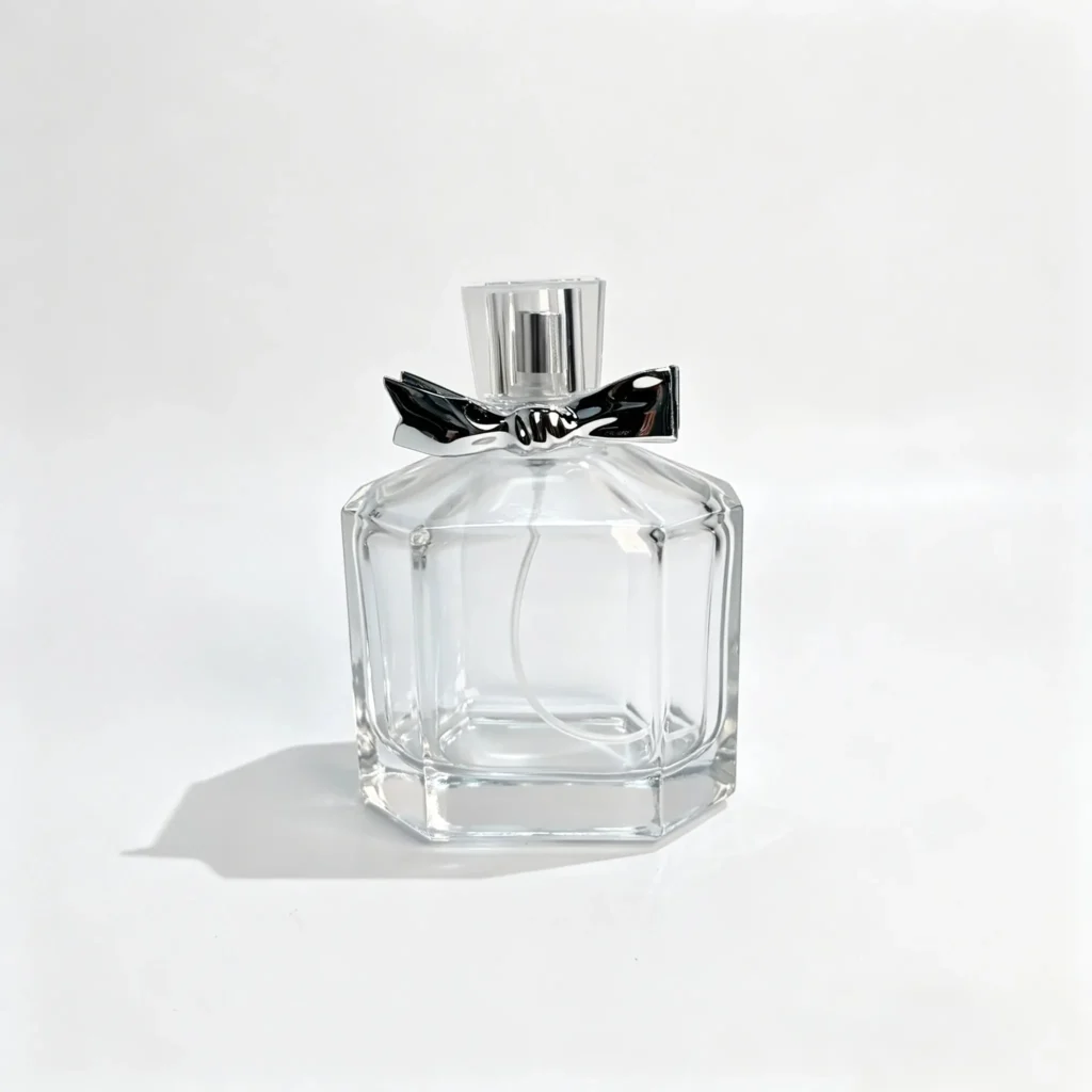 Front view of the 100ml octagonal perfume bottle showing its eight-sided body, decorative bow design, and matching outer cap.