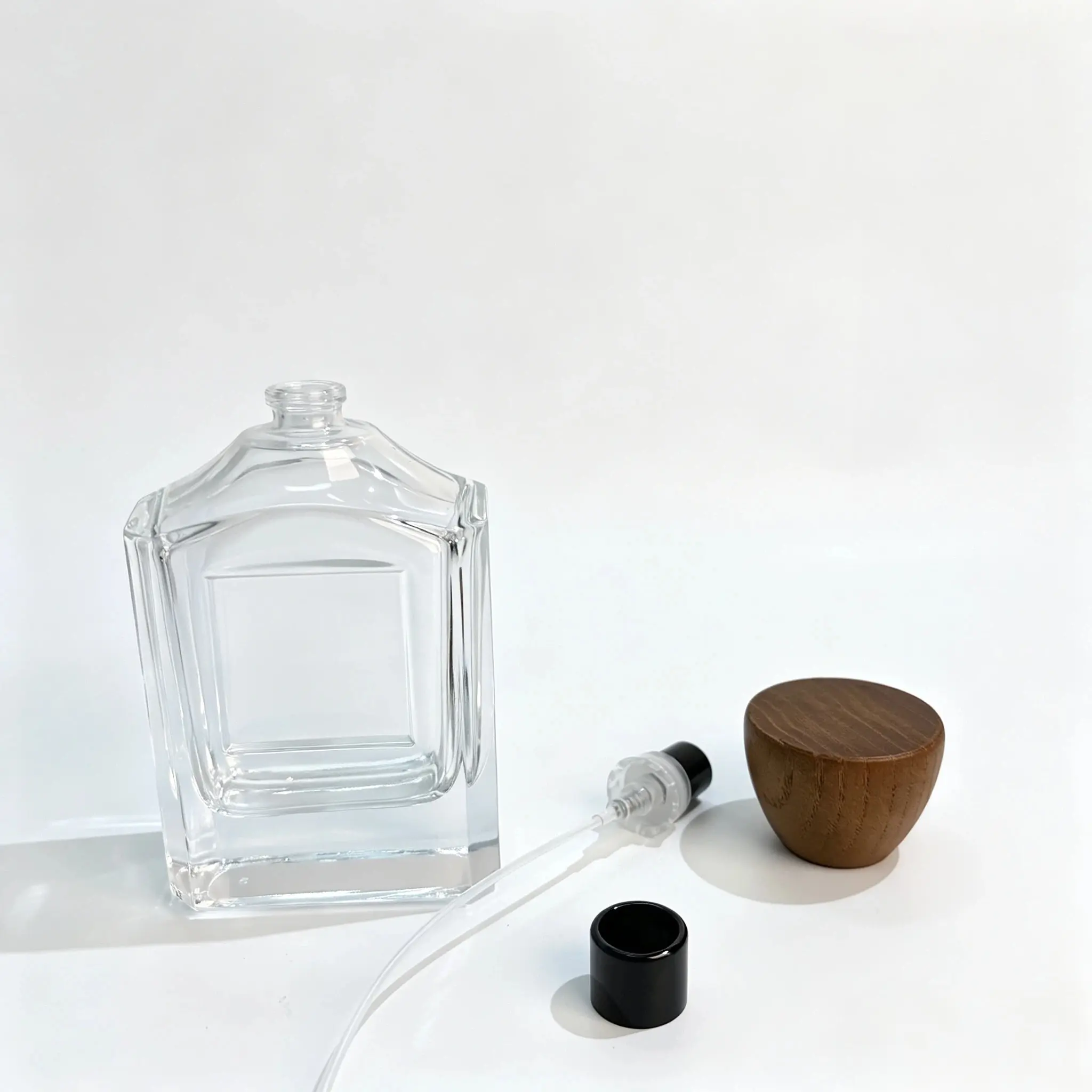 100ml Square Perfume Bottle – Sprayer, Dip Tube and Cap Components 100ml square perfume bottle with separate spray pump, dip tube, and outer cap displayed for fragrance packaging component selection.