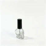 Side profile of the 15ml skull-shaped glass nail polish bottle showing the bottle contour and cap.