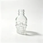 15ml skull-shaped glass nail polish bottle without cap, showing the exposed bottle opening and skull-shaped glass body.