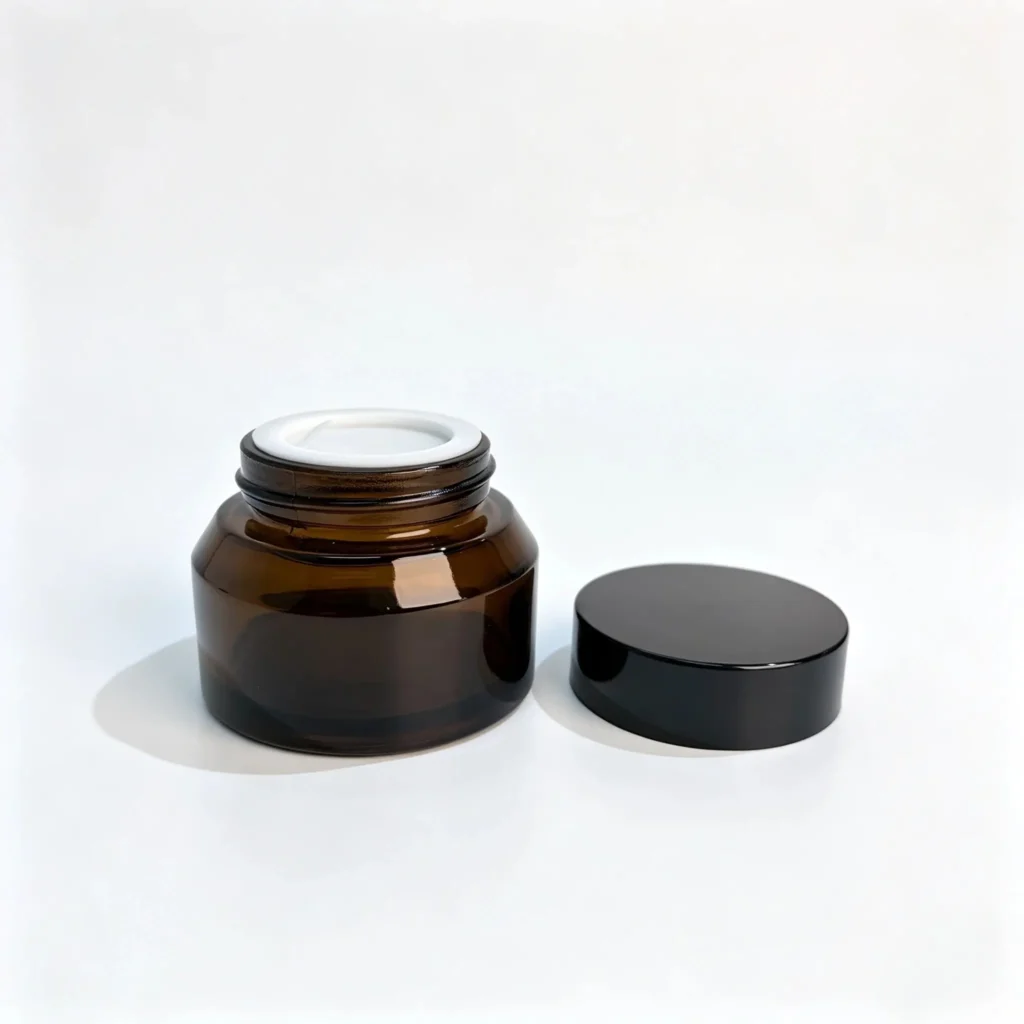 30g amber glass cosmetic cream jar displayed with its separate screw cap to show the container and closure components.