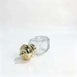 Side-lying view of the assembled 30ml Crown Diamond perfume bottle, highlighting the front of its decorative cap and the overall bottle profile.