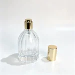 Vertical ribbed 30ml teardrop perfume bottle displayed upright with its decorative cap removed and positioned beside the bottle.