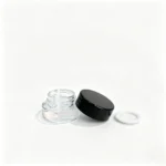 Compact 3g clear glass cosmetic sample jar presented with its black lid for facial cream and skincare sample packaging.