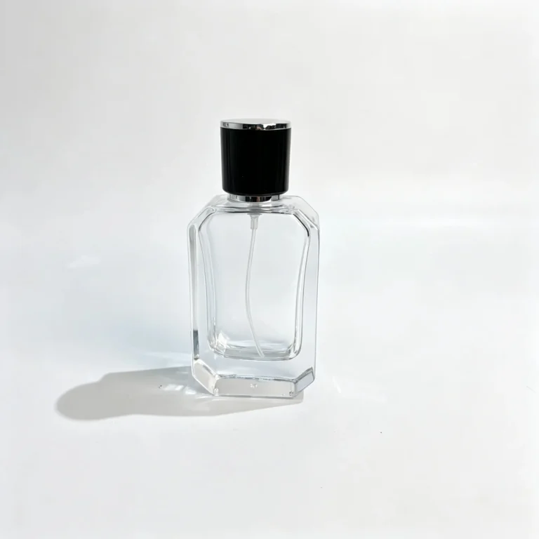 Front view of the 40ml beveled perfume bottle with angled facets and a black cap featuring silver trim.