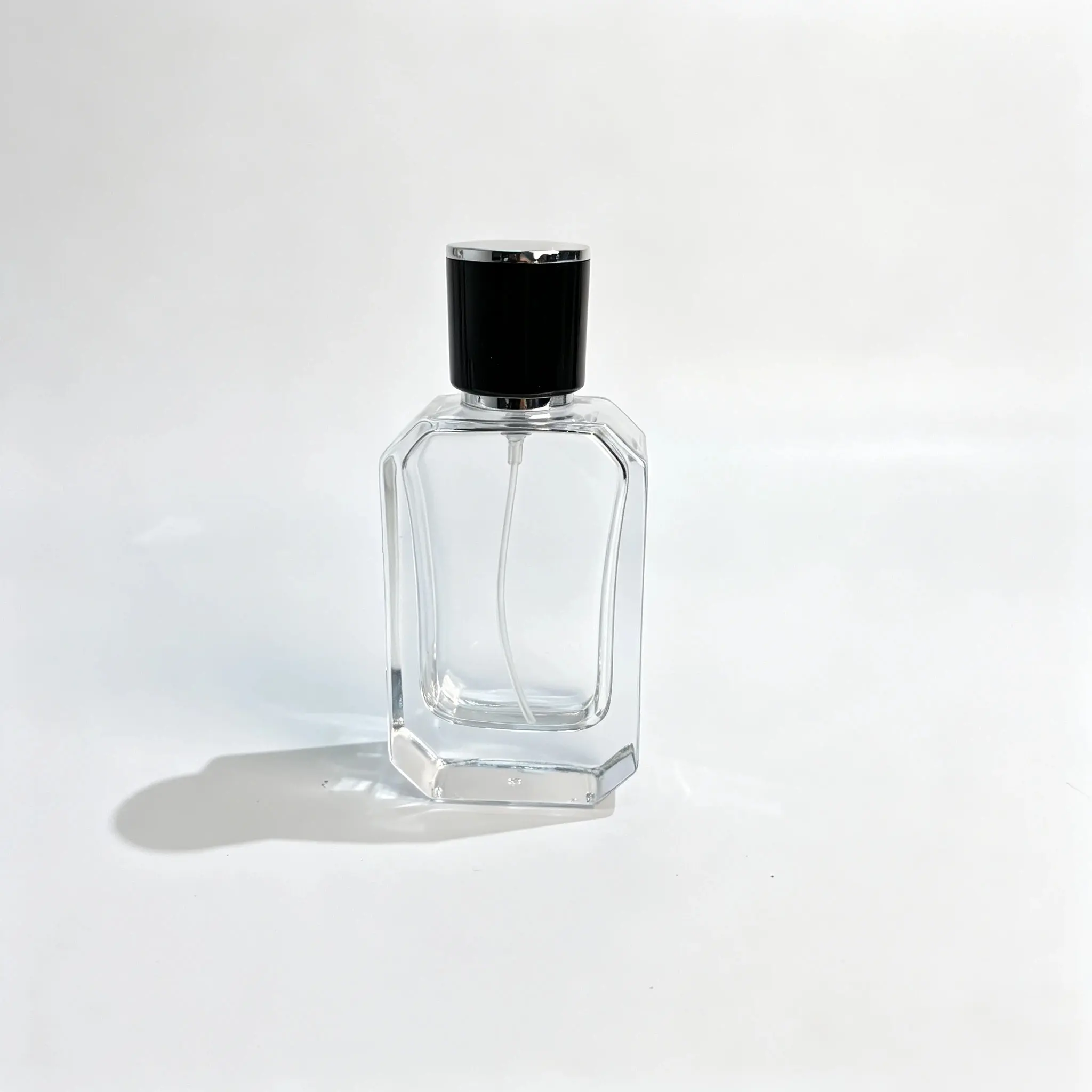 40ml Beveled Perfume Bottle with Black and Silver Cap – Front View Front view of the 40ml beveled perfume bottle featuring an angular faceted body and a black cap with silver trim.
