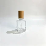Side profile of the 40ml square perfume bottle showing its straight-sided wooden cap, bottle proportions, and thick-base silhouette.