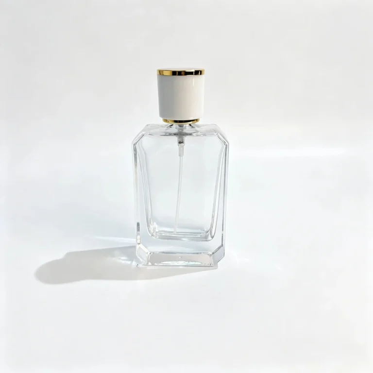 Front view of a 50ml beveled rectangular perfume bottle featuring a slim body with cut corners and a white cap with gold trim.