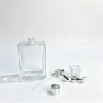 50ml flat rectangular perfume bottle displayed with its separate fragrance sprayer, dip tube, and cap components for bottle and closure matching.