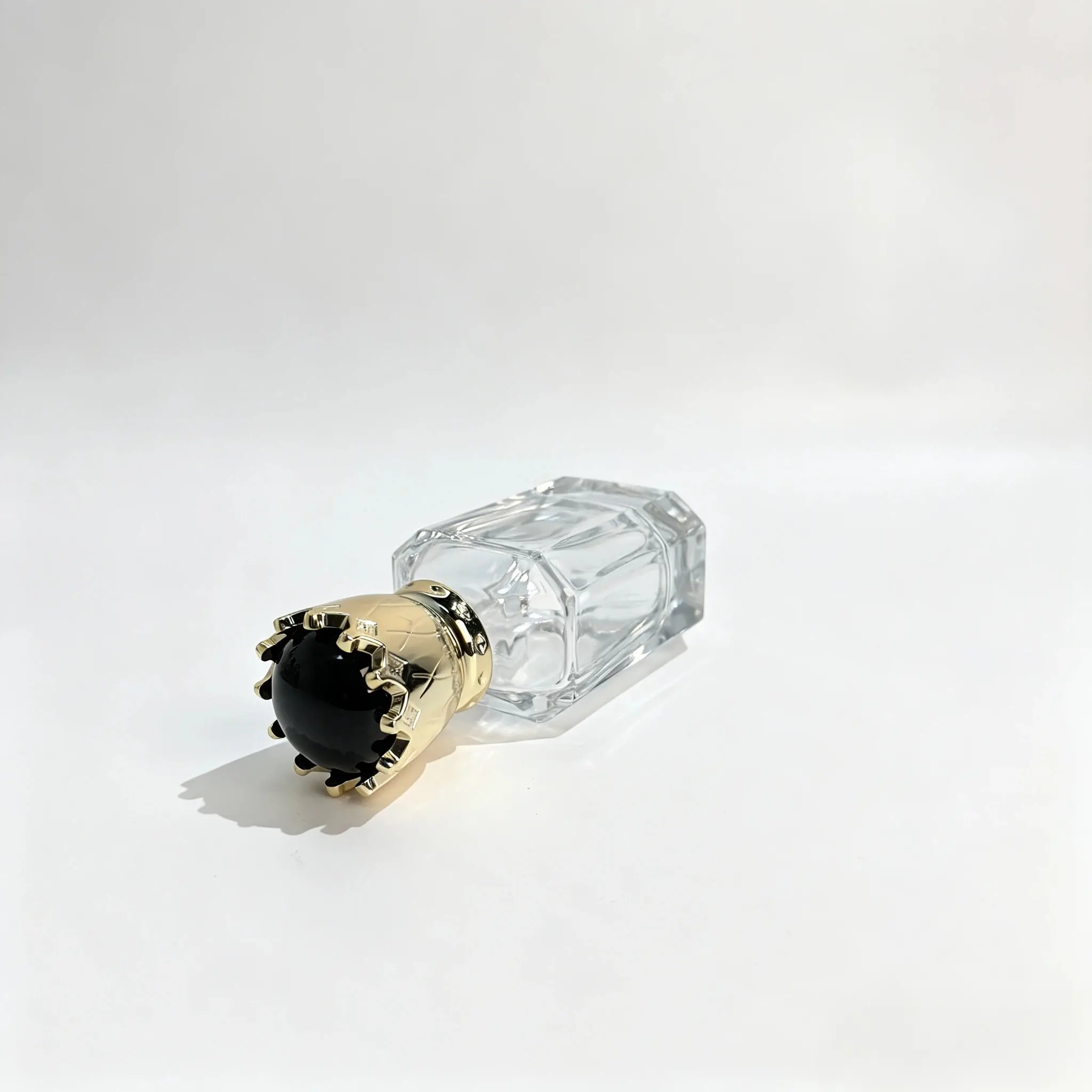 50ml Crown Cap Perfume Bottle – Side-Lying Front View Side-lying front view of the 50ml perfume bottle showing the decorative crown cap and complete bottle presentation from a horizontal angle.