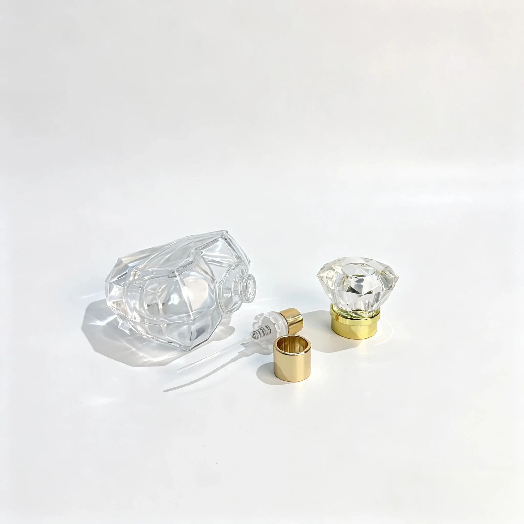 50ml Heart Perfume Bottle – Sprayer, Dip Tube and Faceted Cap Components Separate components of the 50ml heart perfume bottle showing the faceted glass body, gold spray pump, dip tube, and clear decorative cap.